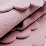 Close-up of the Rosy Mellow Pink Scalloped rug, showing its plush, hand-tufted texture and signature scalloped edge detail.