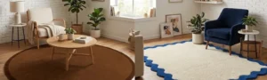 Side-by-side comparison of a solid brown round rug under a wooden coffee table and an off-white scalloped rug with a blue border styled with a navy armchair in modern living room settings.