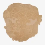 Isolated top-down view of the sand bloom rug on a white background, highlighting its unique, freeform organic shape and monochromatic beige color.