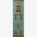 Top-down flat view of the green Tribal Animal Wool Runner Rug, showcasing its scalloped edges and detailed tufted motifs including a tribal mask, palm trees, and two facing leopards on a clean white background.