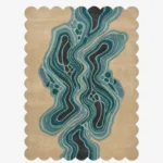 Full top-down view of the rectangular Aqua Drift rug isolated on a plain white background, highlighting its central topographic wavy design in blue and teal tones enclosed by a scalloped border.