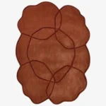 Full top-down product isolated shot of the terracotta colored Aureline irregular area rug featuring an interlocking curved line pattern.
