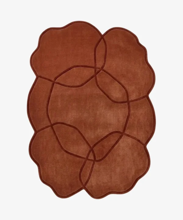 Full top-down product isolated shot of the terracotta colored Aureline irregular area rug featuring an interlocking curved line pattern.