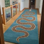 A low-angle side profile view demonstrating the plush depth and striking snake design of the Azure Serpent runner rug.