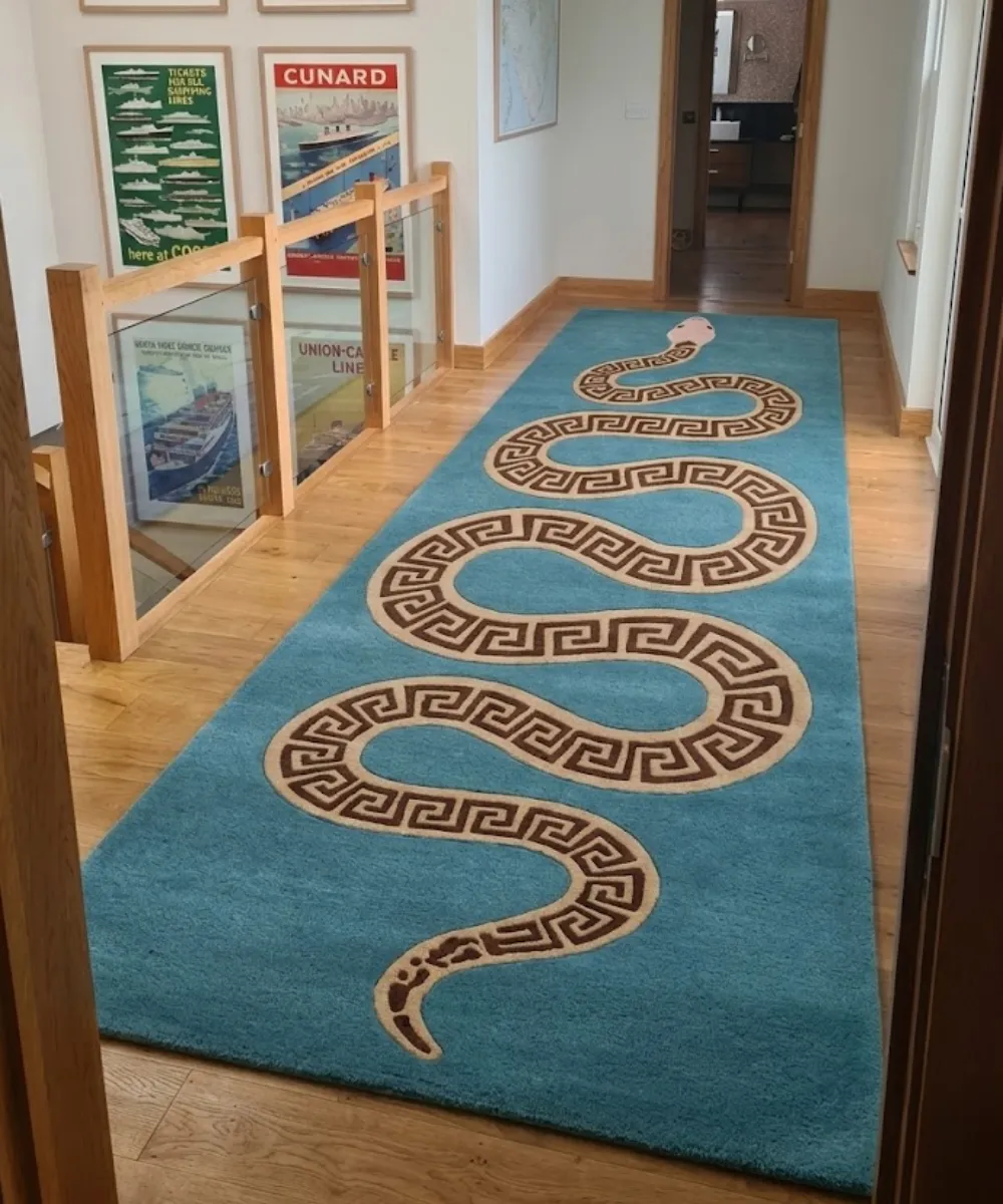 A low-angle side profile view demonstrating the plush depth and striking snake design of the Azure Serpent runner rug.