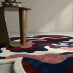 A low-angle perspective shot showing the organic shape and detailed tufted layers of the Bloom Wave rug.