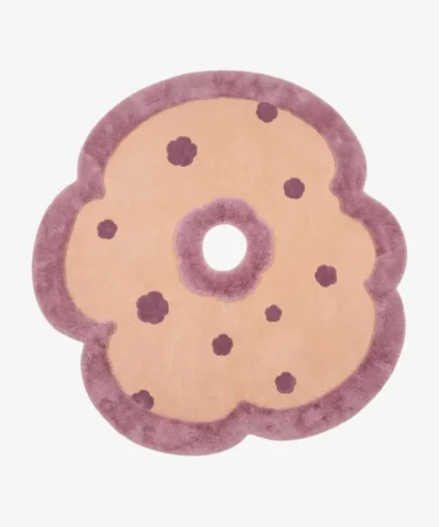 Full top-down product isolated shot of the flower-shaped Camellia Bloom area rug featuring a beige field, deep purple accents, and a plush mauve scalloped border.