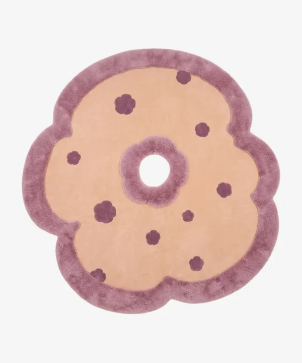 Full top-down product isolated shot of the flower-shaped Camellia Bloom area rug featuring a beige field, deep purple accents, and a plush mauve scalloped border.