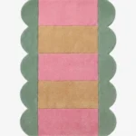 Full top-down product isolated shot of the Candy Stripe scalloped runner rug featuring alternating pink and beige horizontal blocks with a sage green wavy border.
