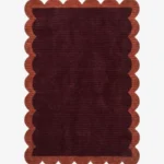 Full top-down view of the rectangular Cinder Scallop rug isolated on a white background, highlighting the solid flat color blocks and uniform scalloped edge pattern.