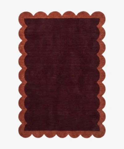 Full top-down view of the rectangular Cinder Scallop rug isolated on a white background, highlighting the solid flat color blocks and uniform scalloped edge pattern.