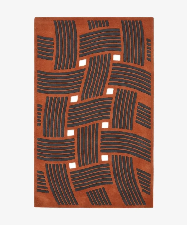 Full top-down product isolated shot of the rectangular Clay Knoty area rug, showcasing a structural basketweave design with raised charcoal grey linear blocks over a rich terracotta orange field with square geometric cutouts.