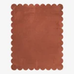 Full top-down view of the Clay Scallop rug isolated on a white background, highlighting its solid terracotta clay color and uniform wavy scalloped edges.