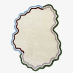 Full top-down product isolated shot of the cream Cloudline Scallop irregular area rug featuring multi-colored wavy borders in green, purple, brown, and blue.