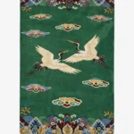Full top-down product isolated shot of the rectangular green Crane Dynasty area rug featuring two elegant white cranes flying among traditional stylized clouds and ornate borders.