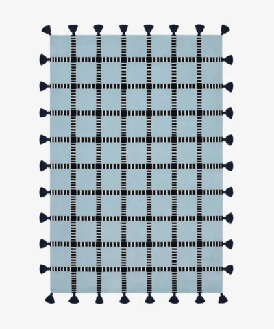 Full top-down product isolated shot of the rectangular light blue Crosshatch area rug featuring a black and white striped windowpane grid pattern and dark navy edge tassels.