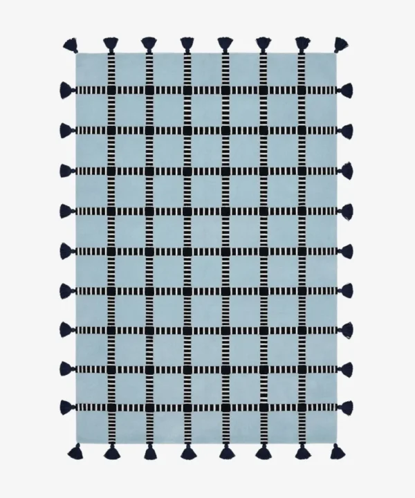 Full top-down product isolated shot of the rectangular light blue Crosshatch area rug featuring a black and white striped windowpane grid pattern and dark navy edge tassels.