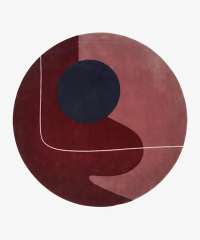 Full top-down product isolated shot of the round Eclipse area rug featuring abstract geometric blocks of burgundy, mauve, and a dark navy circle.