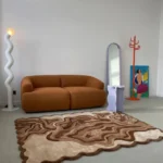 Wide overhead perspective shot of the Ember Terrain scalloped rug styled in a modern living room setting.