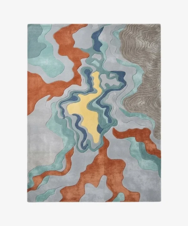 Full top-down isolated product shot of the rectangular Estuary area rug featuring fluid topographical waves in grey, terracotta, aqua, and a central pale yellow pool.
