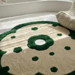 Close-up top angle perspective showcasing the dense pile depth, central cutout ring, and scattered forest green floral motifs of the Fluera rug under soft room lighting.