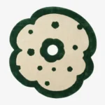 Full top-down product isolated shot of the flower-shaped Fluera area rug featuring an off-white cream field, deep forest green accents, and a plush emerald green scalloped border.