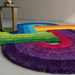 Low angle close-up floor perspective showcasing the plush hand-tufted pile depth and vibrant, distinct color blocks of the purple and green sections on the Funfinity rug.