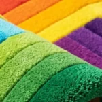 Close-up macro photograph highlighting the premium wool material texture, dense pile tracking, and precision carving of the folded Funfinity retro rug.