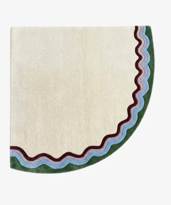 Full top-down product isolated shot of the uniquely shaped Garden Wave corner accent rug featuring a cream base with multi-colored wavy outer borders in green, purple, and burgundy tones.