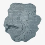 Full overhead product isolated shot of the uniquely shaped blue Glacier Terrain topographical area rug.