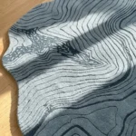 Close-up macro view highlighting the thick, plush material texture and detailed topographic line design of the Glacier Terrain rug.
