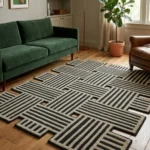 Wide perspective interior lifestyle view of the irregular Grid Theory geometric rug styled on a classic warm oak hardwood floor in a living room featuring a forest green velvet sofa.