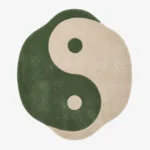 Full top-down view of the Harmony Flow rug isolated on a plain white background, featuring a classic yin yang design rendered in solid blocks of sage green and off-white.