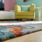Close-up macro photograph highlighting the premium wool material texture and dense multi-level pile of the folded Landform Drift area rug.