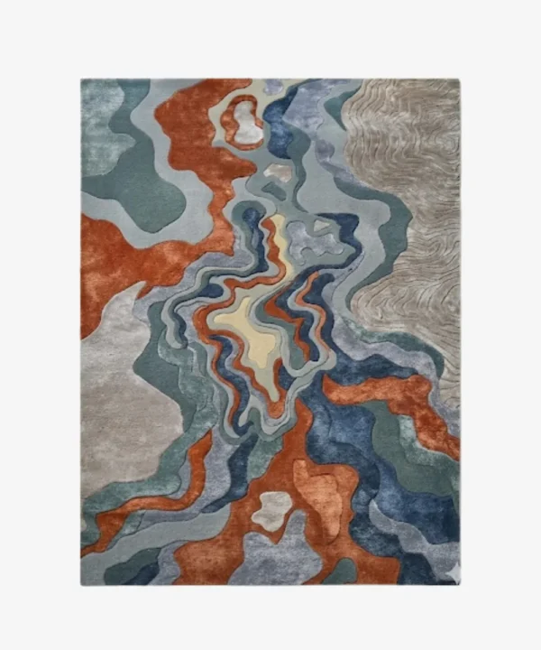 Full top-down product isolated shot of the uniquely shaped Landform Drift abstract rug, featuring fluid topographical layers in rust, blue, green, and beige.