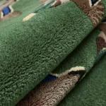Close-up macro photograph highlighting the thick, plush wool material texture and clean pattern design of the Mallard Duck Flight rug.