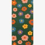 Full top-down product isolated shot of the green rectangular Meadow Bloom runner rug featuring a repeating retro pattern of colorful daisies.