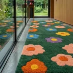 Low side-angle close-up perspective showing the detailed plush pile depth and colorful daisy pattern transitions of the Meadow Bloom rug.