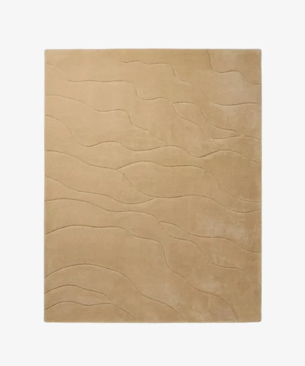 Full top-down product isolated shot of the rectangular Mira Sand area rug, featuring a subtle monochromatic design with organic wavy etched lines running across a solid warm sand beige field.
