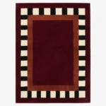 Full top-down product isolated shot of the rectangular Montero Border rug featuring a deep red center and black and white checkered border.