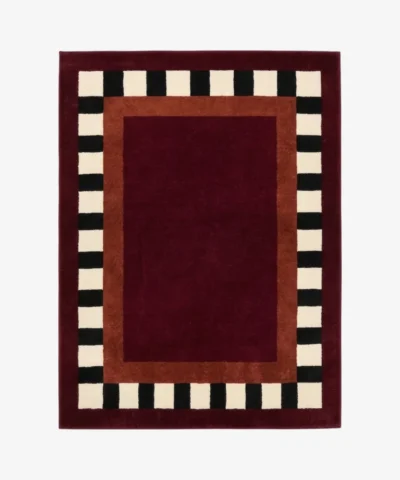 Full top-down product isolated shot of the rectangular Montero Border rug featuring a deep red center and black and white checkered border.