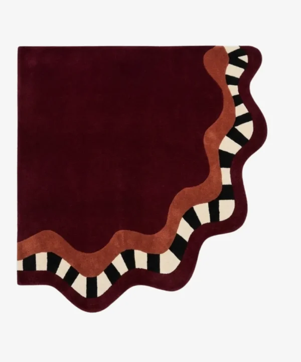 Full top-down product isolated shot of the uniquely shaped Mulberry Tide scalloped corner rug featuring a deep burgundy field with terracotta and checkered wavy borders.