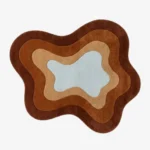 Full top-down view of the custom fluid Oasis rug isolated on a plain white background, highlighting its concentric wavy design in shades of brown, terracotta, beige, and light blue.
