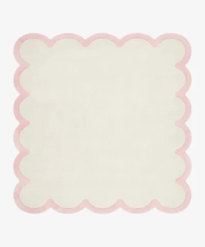 Full top-down product isolated shot of the cream and pink Opaline scalloped rug.