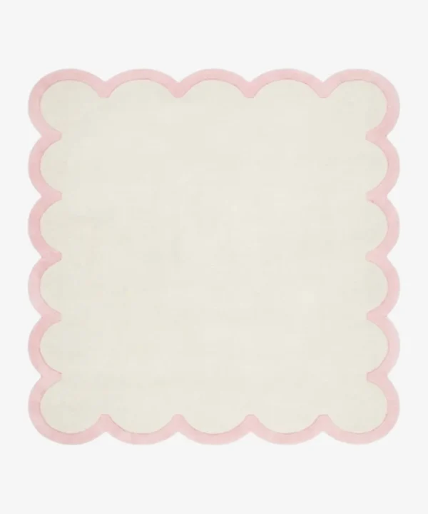 Full top-down product isolated shot of the cream and pink Opaline scalloped rug.