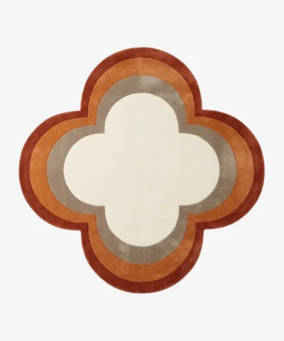 Full top-down product isolated shot of the custom quattrofoil-shaped Petra Halo area rug, featuring concentric retro border rings in rust red, burnt orange, and taupe grey surrounding a solid ivory white center field.