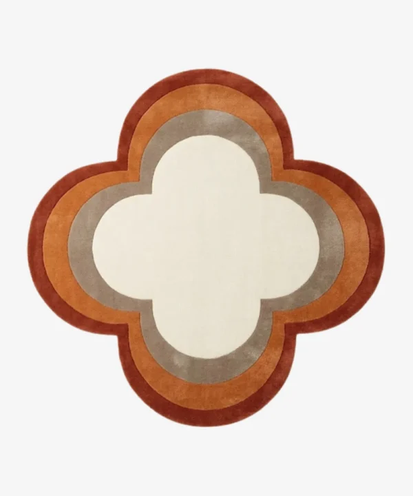 Full top-down product isolated shot of the custom quattrofoil-shaped Petra Halo area rug, featuring concentric retro border rings in rust red, burnt orange, and taupe grey surrounding a solid ivory white center field.
