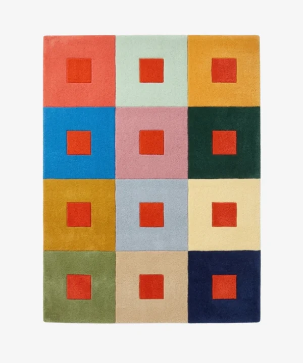 Full top-down product isolated shot of the rectangular Pixel Palette area rug featuring a geometric grid of twelve multi-colored blocks, each accented with a bold red center square.