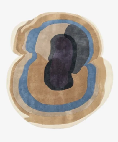 Full top-down product isolated shot of the uniquely shaped Sediment abstract rug featuring organic fluid layers in shades of beige, blue, and deep purple.