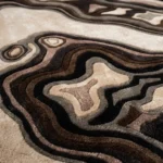Low angle close-up floor perspective showcasing the plush hand-tufted pile and intricate, high-contrast layered depth of the Shadow Canyon rug.